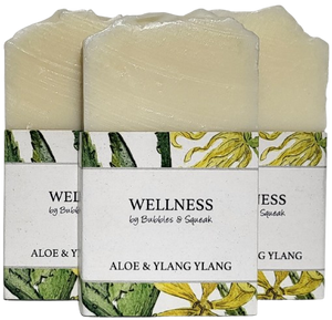 Three bars of just soap aloe and ylang ylang, one in front of two others, no background