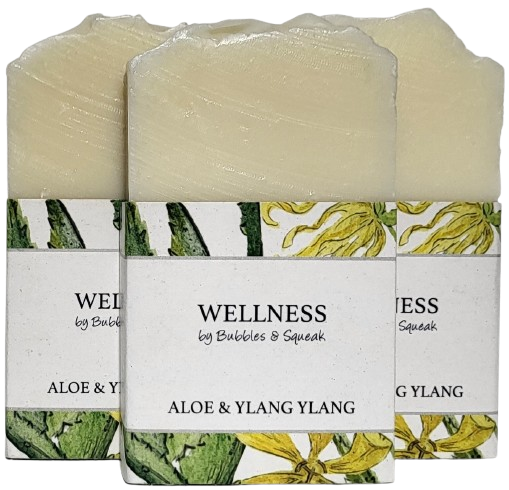 Three bars of just soap aloe and ylang ylang, one in front of two others, no background