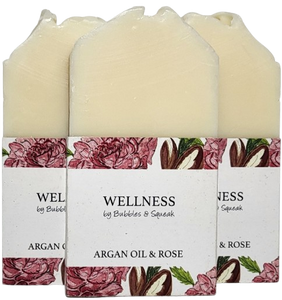 Three bars of just soap argan oil and rose, one in front of two others, no background