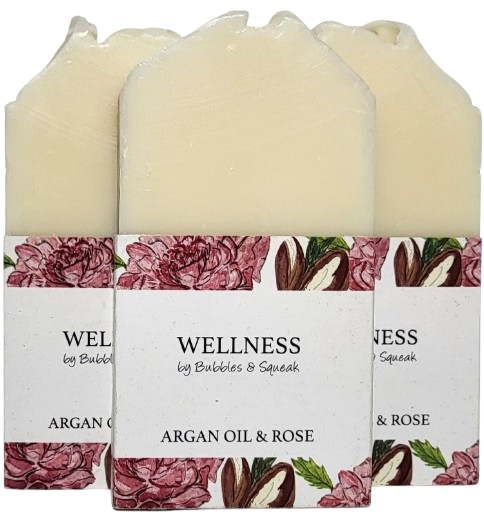 Three bars of just soap argan oil and rose, one in front of two others, no background