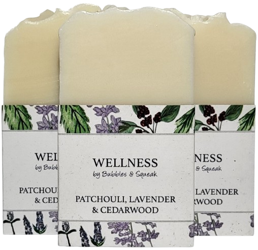 Three bars of just soap patchouli lavender and cedarwood, one in front of two others, no background