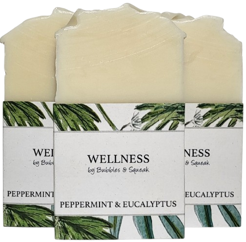 Three bars of just soap peppermint and eucalyptus, one in front of two others, no background