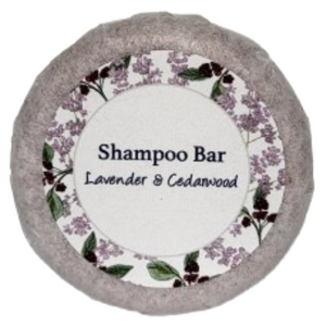 A round bar of orange, patchouli and lavender shampoo on a blank background