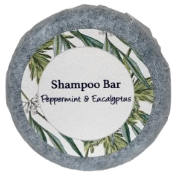 A round bar of peppermint and eucalyptus shampoo on a blank background