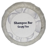 A round bar of simply pure shampoo on a blank background