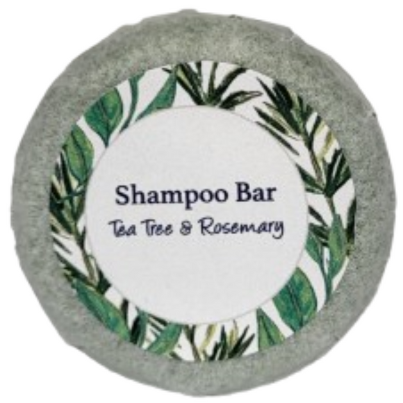 A round bar of tea tree and rosemary shampoo on a blank background